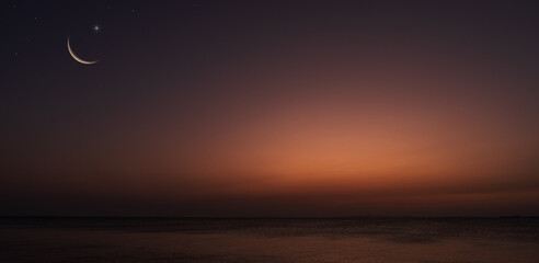 Dusk sky over sea in the evening on twilight with crescent moon well space for text 