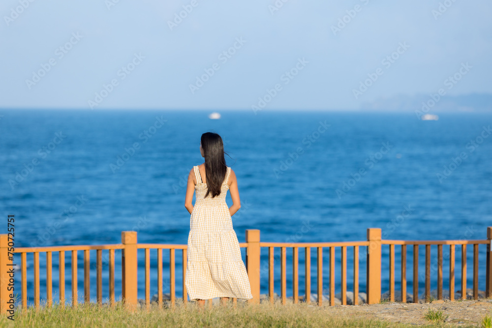 Canvas Prints asian woman wear dress and look at the sea