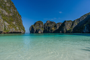   Famous Maya Bay beach at Ko Phi Phi Leh Island morning light , crystal clear water, steep limestone hills in background. Main Thailand tourist attraction, Krabi, Andaman Sea in 2024 post-COVID