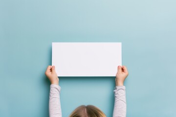 portray of child holding blank paper banner