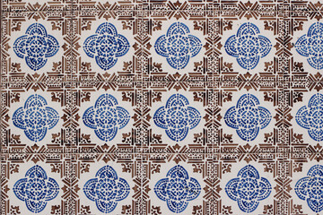 Blue and brown Portuguese ceramic tile pattern, azulejos. Beautiful shabby facade, wall decoration of old Lisbon building, Portugal. Decorative background. Geometric floral ornaments. Moroccan style.