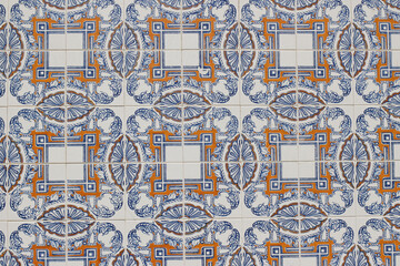 Detail of decorative floral tiles. Blue, orange ornamental traditional Portuguese ceramic tile pattern, azulejos. Beautiful facade, wall decoration of old Lisbon building. Decorative background.