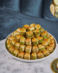 A picture of a plate of Arabic sweets with pistachios, Ramadan sweets