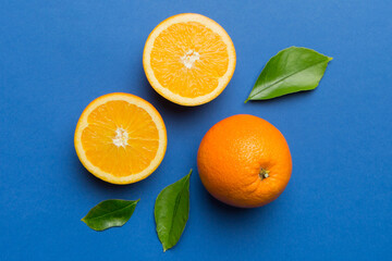 Fruit pattern of fresh orange slices on colored background. Top view. Copy Space. creative summer concept. Half of citrus in minimal flat lay