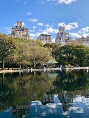 Obraz premium Central Park, buildings and trees reflection on lake. New York, United States. New York City skyline view from Central Park, New York, United States
