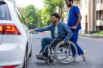 Fototapeta na wymiar Man in a wheelchair opening a car door