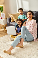 cheerful little african american boys sitting next to their beautiful mother looking at camera