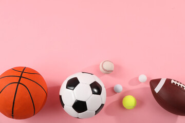 Many different sports balls on pink background, flat lay. Space for text