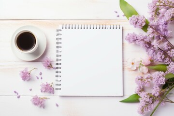 Coffee Cup, Notebook, and Flowers on Table