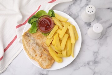 Delicious fish and chips with ketchup, spinach and lettuce on light marble table, flat lay