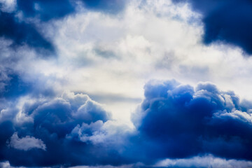Close-up of stormy blue clouds in the sky, textured clouds on a blue sky.