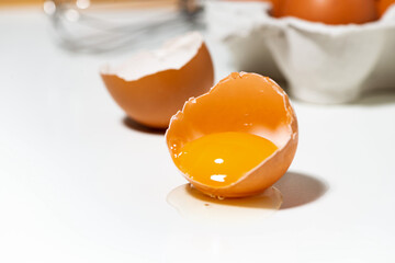 broken chicken egg on white background, baking ingredients, closeup