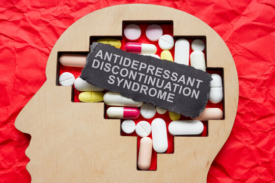 Head with pills and inscription antidepressant discontinuation syndrome.