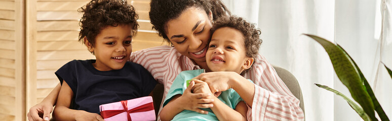 happy african american family spending time together with present in hands, Mothers day, banner
