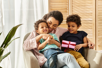 joyful african american family of three spending time together, present in hand, Mothers day