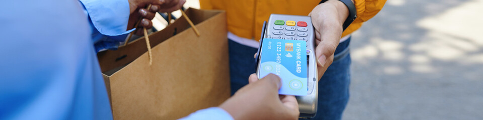 Web banner with customer paying for food delivery with credit cards