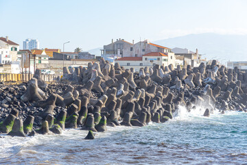 coast facing the Atlantic Ocean with breakwater barriers built by countless concrete tetrapods