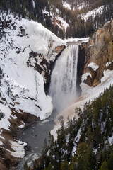 Snowy lower falls of the yellowstone national park at sunset