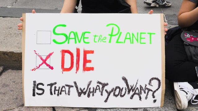 Girl with signs "Save the planet or die" at Fridays for future demonstration, Milan, Italy