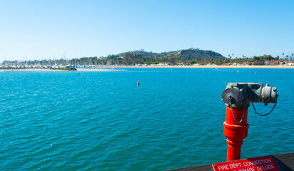 Fire Hydrant in Santa Barbara pier with the shoreline on the background - 750775764
