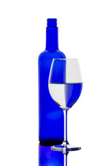 A colorful bottle with reflections in a wine glass
