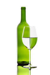 A colorful bottle with reflections in a wine glass
