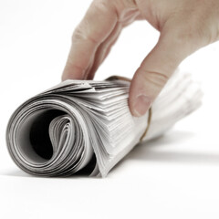 Hand Reaching for Paper Newspaper Rolled Up