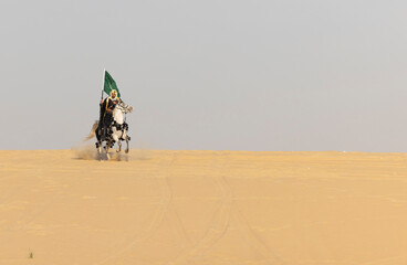 Saudi man in traditional clothing in the deset with a white horse