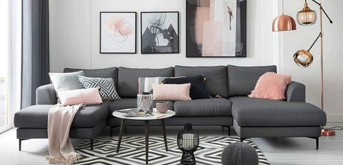Charcoal gray sofa, rose gold accents, white wall with abstract black and white chevron.