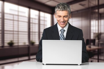 Excited professional business man looking at laptop