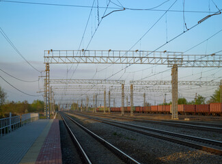 View of the railway and infrastructure and power lines at sunset