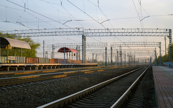 View of the railway and infrastructure and power lines at sunset