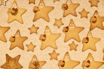 Baked cookies with faces and nuts in your hand. Big and small stars