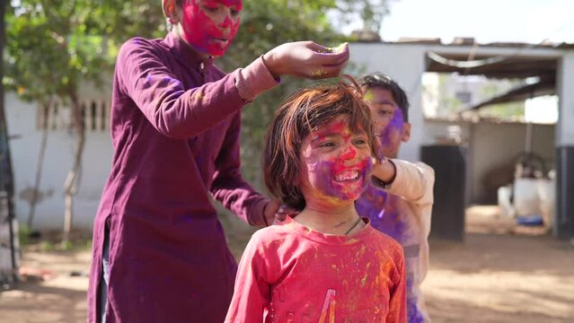 Celebration of Holi festival day colorful footage of Group of Cheerful kids playing holi