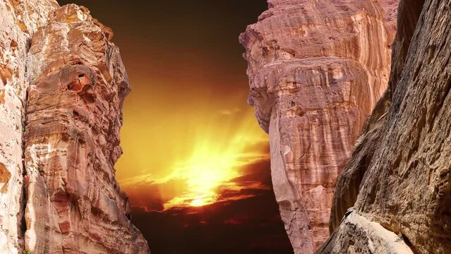 Mountains (rocks) of Petra, against the background of the sunset (4K, time lapse, with zoom), Jordan, Middle East. Petra has been a UNESCO World Heritage Site since 1985