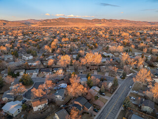 winter morning over a residential street in Fort Collins and Rocky Mountains foothills in northern Colorado, aerial view