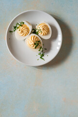 Deviled eggs with fresh herbs, perfect Easter party appetizer, directly above - 750794370