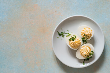 Deviled eggs with fresh herbs, perfect Easter party appetizer, directly above - 750794371