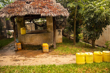 An old well with jerricans line around it 