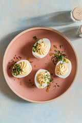 Deviled eggs with fresh herbs and spicy oil, perfect Easter party appetizer, directly above - 750794737