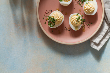 Deviled eggs with fresh herbs and spicy oil, perfect Easter party appetizer, directly above - 750794985