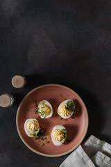 Deviled eggs with fresh herbs, perfect Easter party appetizer, directly above - 750794986
