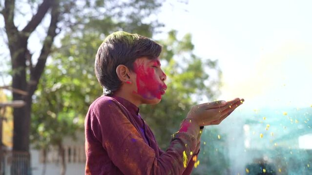 Kids gathering together celebrating a Holi party in the outdoor with happiness expressions and covered with vivid holi colors.