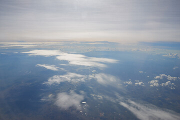 Aerial view seen over clouds from aircraft. © Heorshe