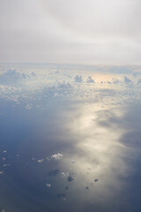 Aerial view seen over clouds from aircraft.