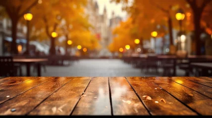 Foto op Canvas The empty wooden table top with blur background of European street in autumn. Exuberant image. generative AI © Summit Art Creations