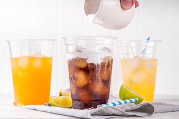 Dirty soda, soda and cream alcohol free mocktail. Iced sweet soda drink with non-dairy creamer,...