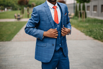 Stylish luxury men's casual blue checkered suit and red tie. African American model