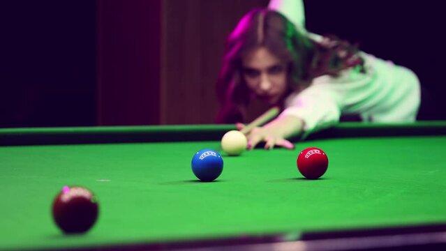Woman in billiards stance, aiming cue at snooker balls on green table. Snooker game, tournament. Social club membership brochure. Concept of billiards sport, gambling, hobby, leisure, game