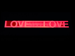 Love word in pink made moving a stencil